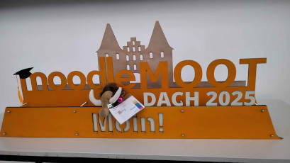 Moothel with the MoodleMoot DACH 2025 Lübeck Logo in front of the Holstentor